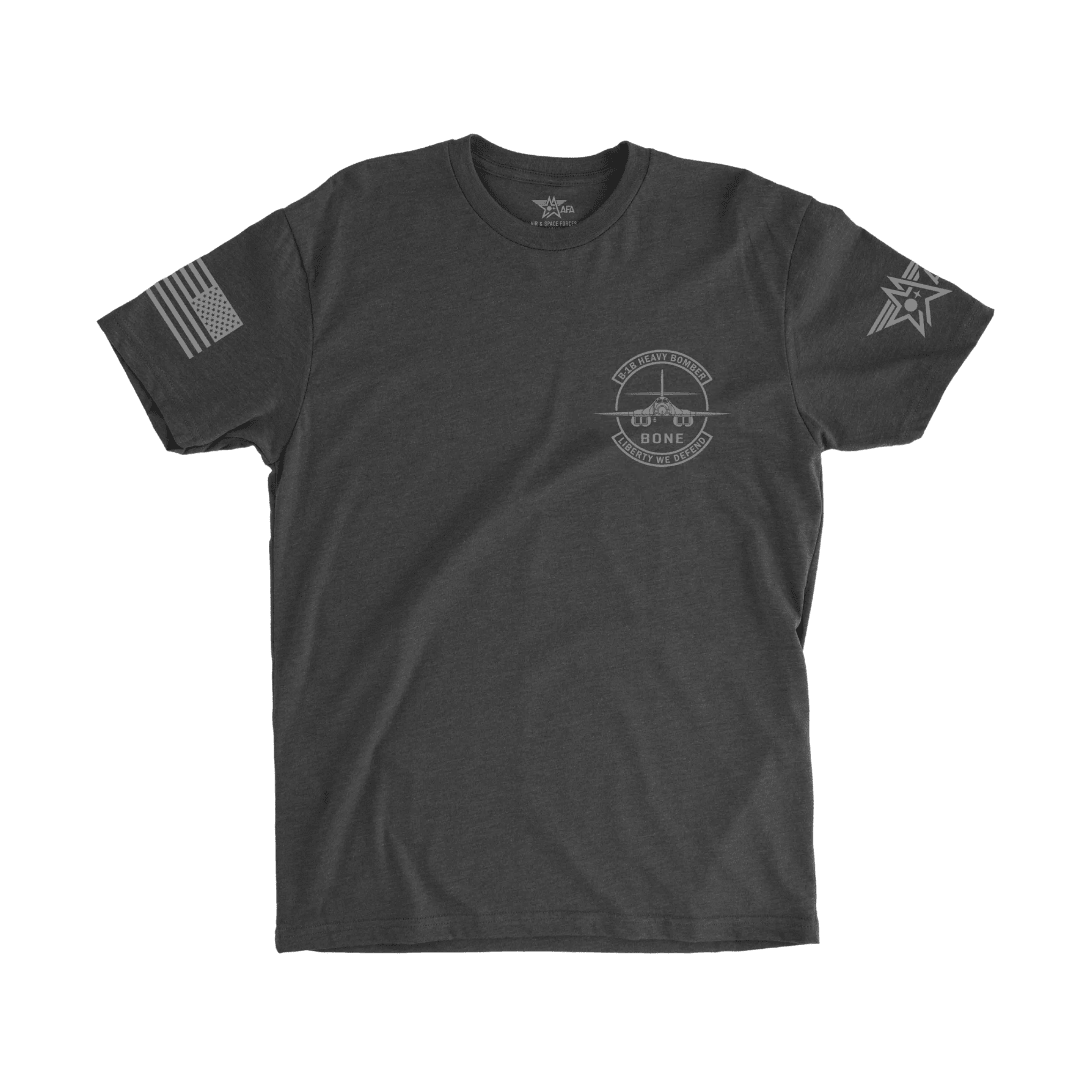 Black t-shirt with logos on sleeves and chest on a white background