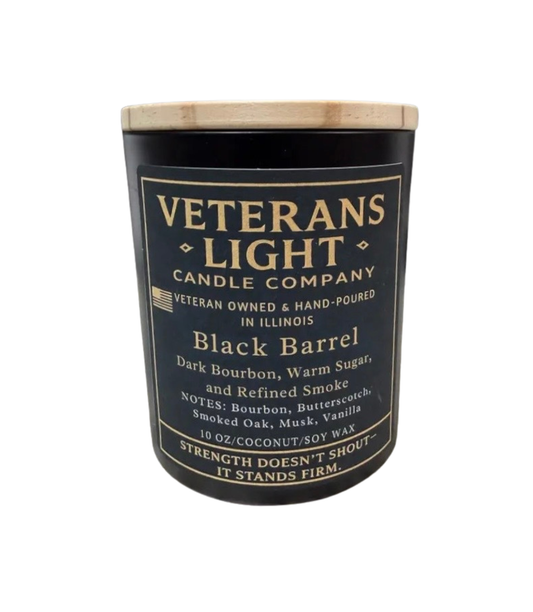 Veterans Light Candle Company candle with black label and wooden lid on a white background
